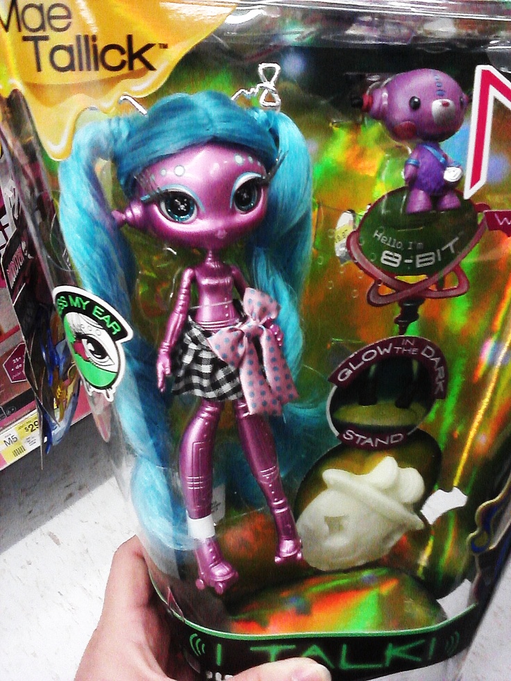 a person is holding up a toy in a plastic case with other toys behind it