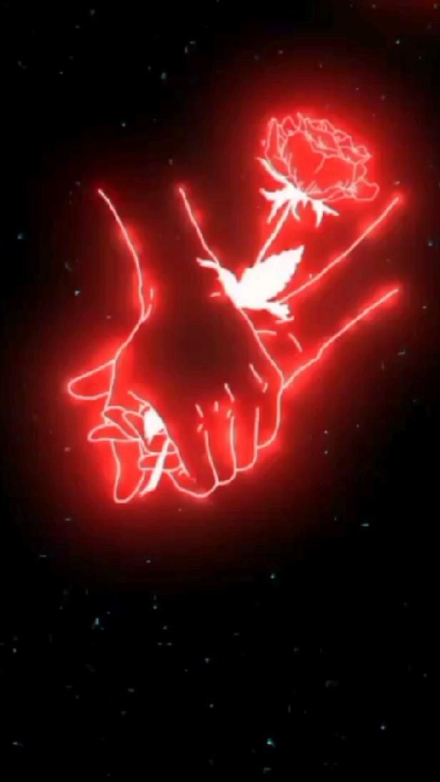 two hands touching each other with red light in the dark sky behind them and stars