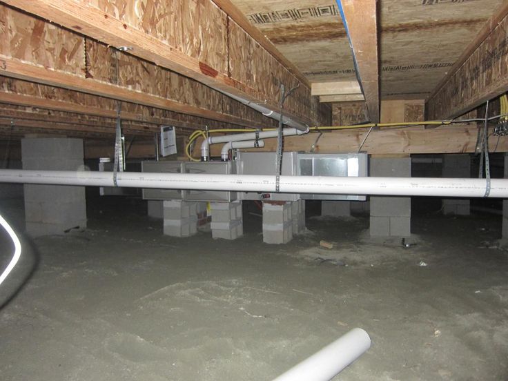 the inside of a building with pipes and boxes