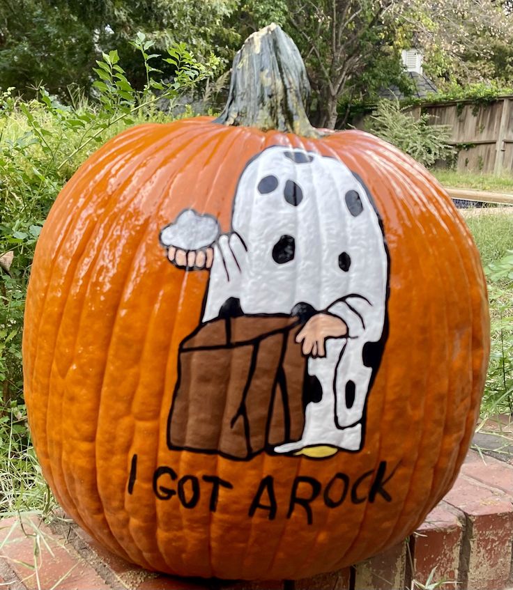 a pumpkin with a cartoon character painted on it's face and the words, i got a rock