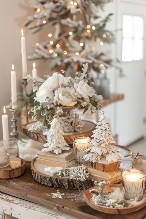 a table topped with candles and flowers on top of a wooden tray next to a christmas tree