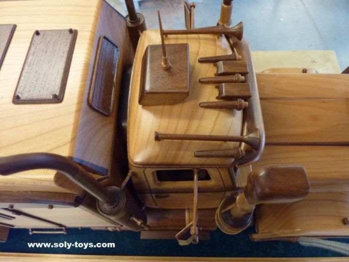 a wooden model of a boat with many tools on it's back end and sides