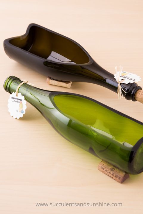 a wine bottle with a cork in it sitting on a table next to a glass bottle