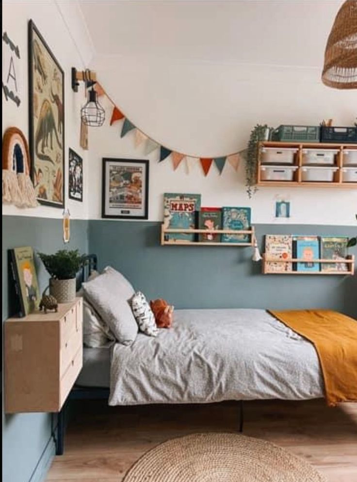 a bed room with a neatly made bed and lots of pictures on the wall above it