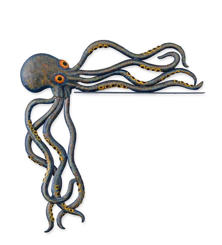 an octopus sculpture with orange eyes on it's head and tentacles hanging from the wall