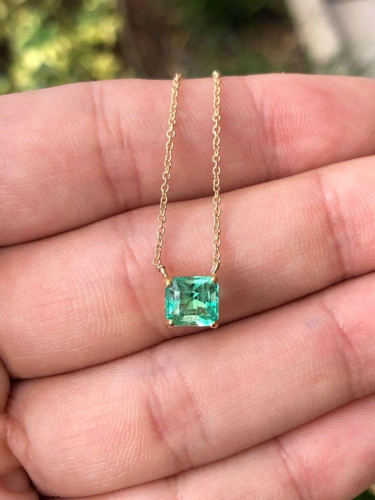 Featured here is a 1.32-carat stunning, Colombian emerald necklace in fine 14K yellow gold. Displayed in the center is a medium-light green emerald with incredible crystal clarity, accented by a simple four-prong gold mount, allowing for the emerald to be shown in full view. The earth mined, green Colombian emerald has a desirable lush green color with excellent qualities. An 18 inch is attached to the emerald pendant. This necklace is ideal for everyday use and is the perfect accessory to any o Dainty Luxury Emerald Necklace As Birthstone, Emerald Cut Solitaire Necklace In 14k Gold, 14k Gold Emerald Cut Solitaire Necklace, Fine Jewelry Green Diamond Cut Necklaces, 14k Gold Emerald Cut Fine Jewelry Necklace, Elegant Gold Gemstones Gia Certified, Elegant Gold Gia Certified Gemstones, Gia Certified Yellow Gold Necklace For Formal Occasions, Formal Yellow Gold Gia Certified Necklace