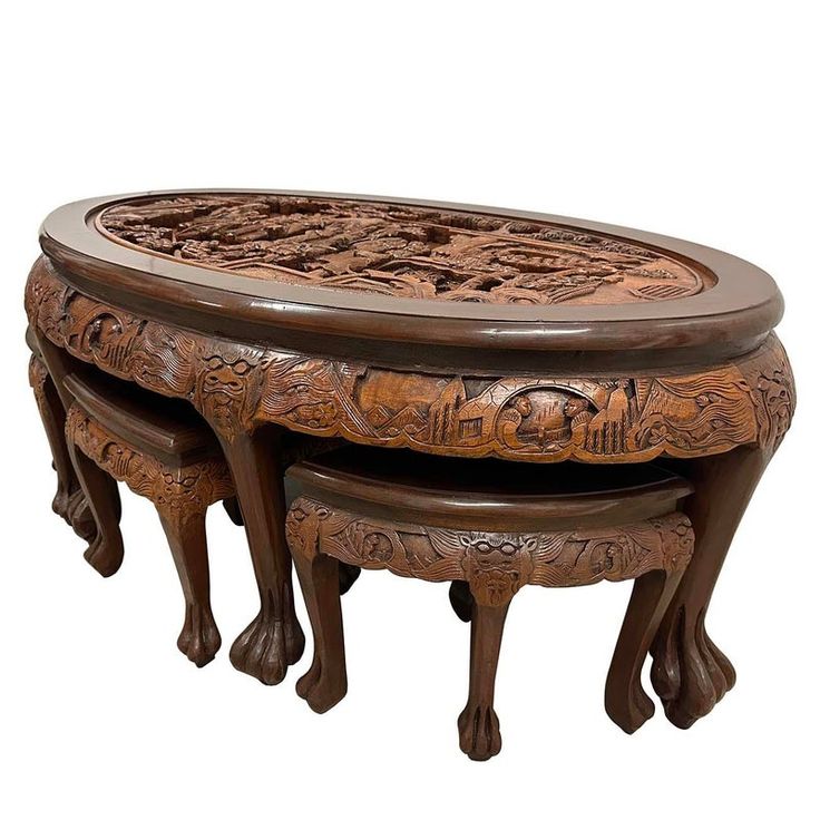 three wooden tables with carved designs on them