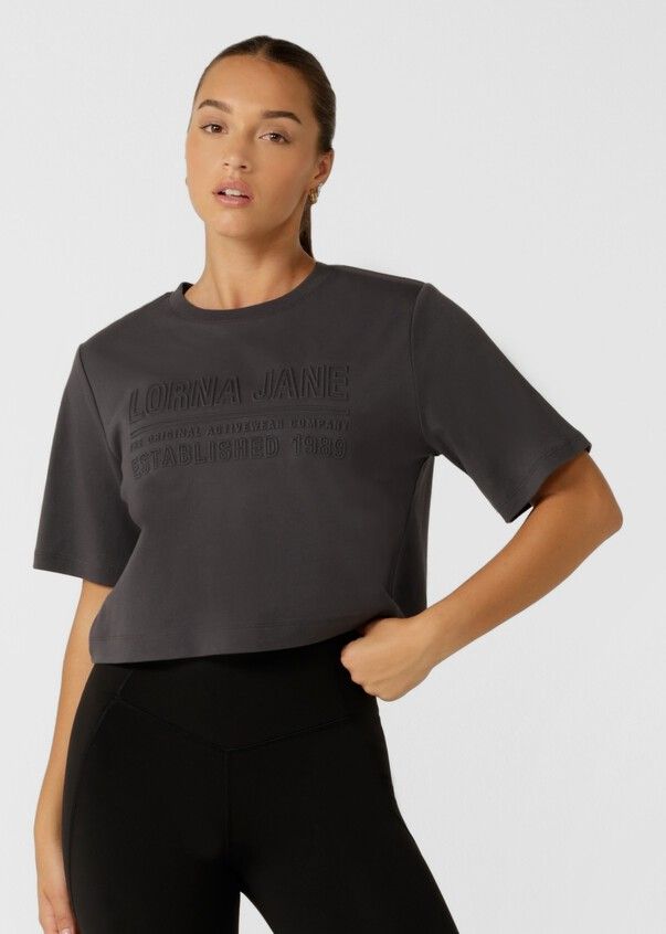 Authentic Classic Tee | Short Sleeve | Lorna Jane USA Athleisure Crew Neck Shirt With Graphic Print, Gray Crew Neck Athleisure Tops, Athleisure Gray Short Sleeve Top, Gray Short Sleeve Top Athleisure, Gray Short Sleeve Top For Athleisure, Gray Relaxed Fit Workout Tops, Gray Graphic Print Short Sleeve Tops, Athleisure Cotton Tops With Text Print, Athleisure Tops With Graphic Print And Short Sleeves