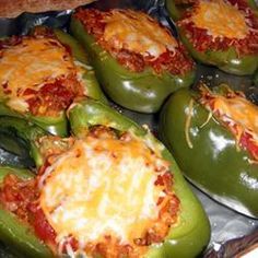 several green peppers covered in cheese and sauce