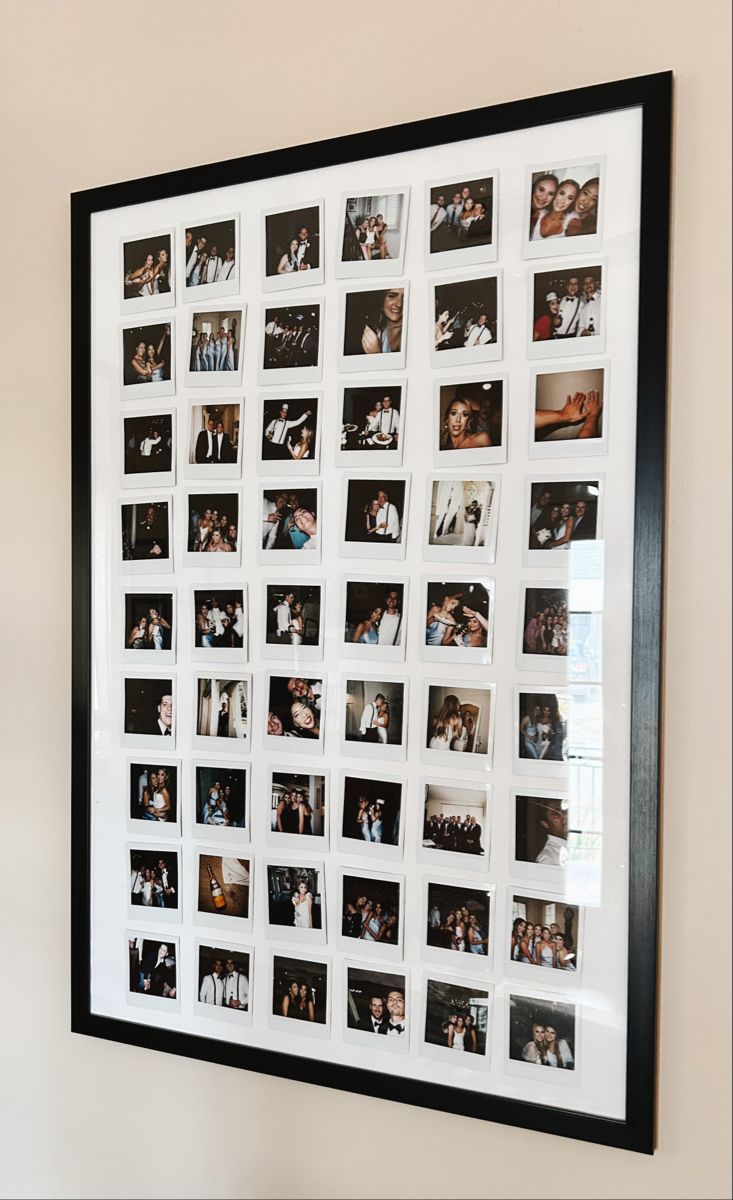 a black and white photo hanging on the wall with many photos attached to it's frame