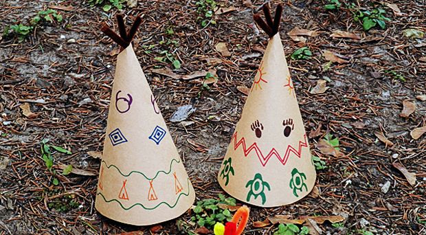 two paper cones with numbers on them sitting in the grass