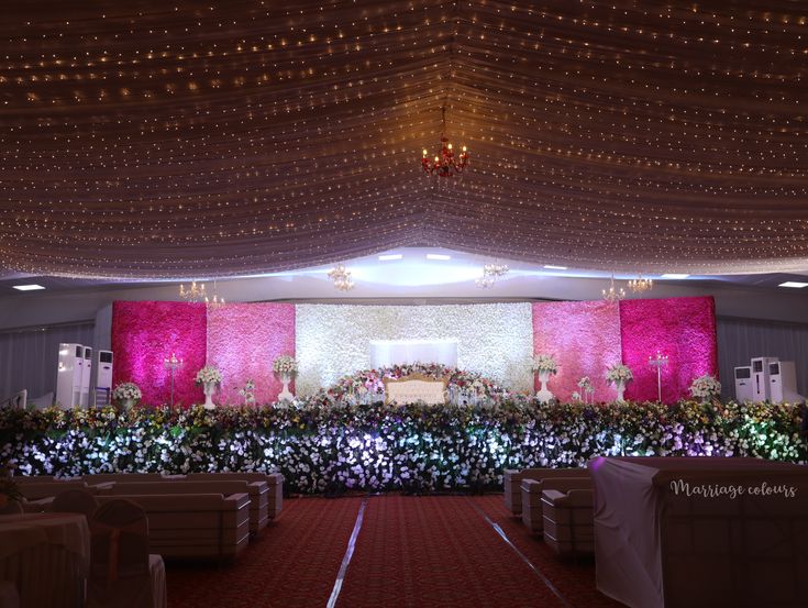 an indoor wedding venue decorated with flowers and greenery