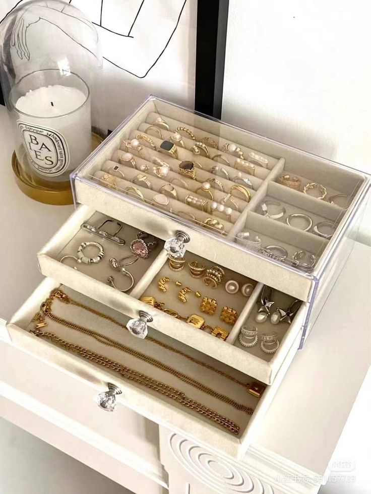 an open jewelry box sitting on top of a white table