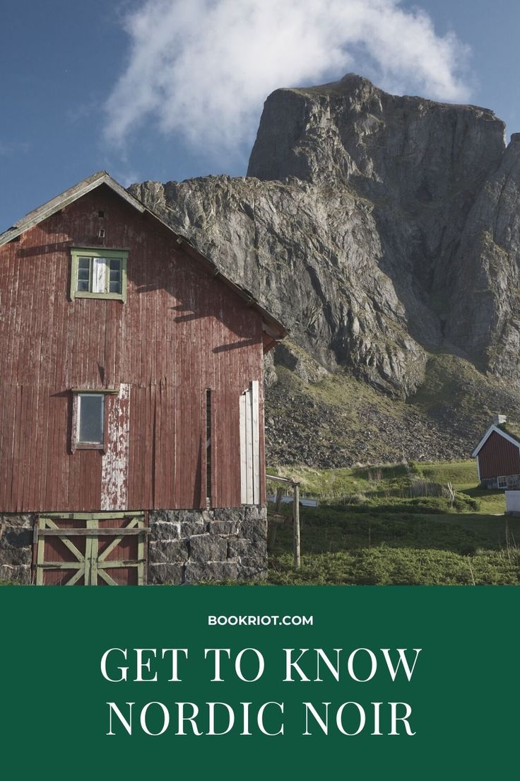 a red barn sitting in front of a mountain