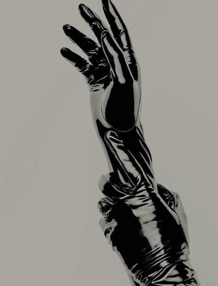 a black and white photo of a person's hand reaching up