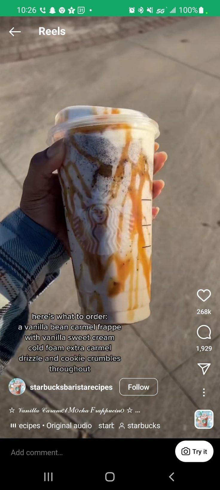 someone holding up a cup with some liquid on it