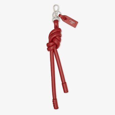 Oversized knot-shaped key ring, inspired by the long zip-pulls on this season’s new bags. The clip allows it to be attached like a charm to bags or other accessories. Customised with logo tag. Made of soft, red leather. Palladium-finish metalware. Made in Italy. One Size Luxury Bag Charm With Keychain, Leather Key Case, New Bags, Leather Crafts, Leather Keyring, Soft Red, Fragrance Gift, Logo Tag, Women Essentials