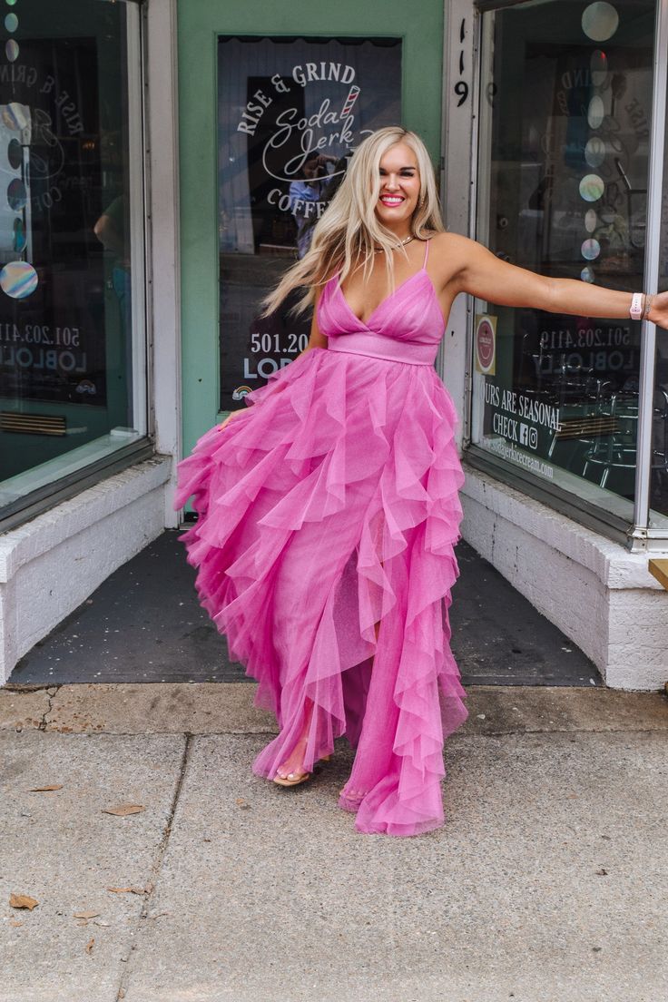 Get ready to dazzle in our Dangerously Perfect Pink Ruffle Dress! This elegant and formal dress features a sparkly fabric that will definitely make you stand out in any crowd. Perfect for a special occasion or a night out, this dress is dangerously perfect in pink! Glamorous Pink Evening Dress For Homecoming, Flirty V-neck Prom Dress, Pink V-neck Evening Dress For Party, Pink Tulle Dresses For Prom Season, Pink Tulle Evening Dress For Party, Chic Pink Prom Evening Dress, Glamorous Summer Homecoming Evening Dress, Elegant Maxi Dress With Ruffles For Prom, Elegant Prom Dress With Ruffles In Maxi Length