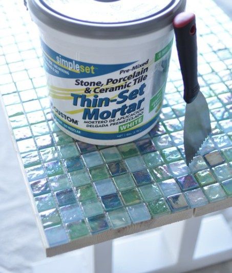 a can of tile sitting on top of a table with a spatula in it