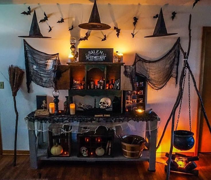 a room decorated for halloween with candles and decorations