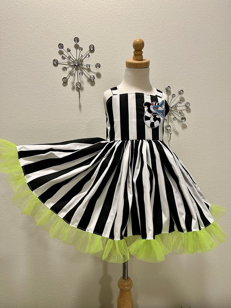 a black and white striped dress on a mannequin with lime green tulle