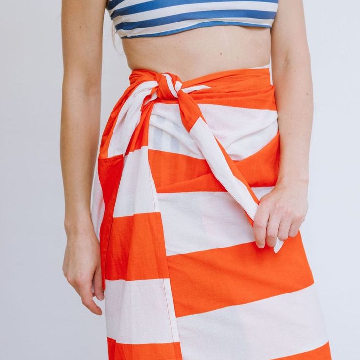 A sarong is the best accessory for your days at the pool or beach. And takes up zero room in your suitcase when you're packing for your beach vacation! Breezy, comfortable, and versatile our Capitana Stripe Sarong can be worn tied around the waist or even tied around the neck as a dress. Keep it classic in vibrant red and bold stripes! The Monogram Shop is open! Customize your sarong with a 1" Navy monogram that can feature 1-3 letters. Monograms are embroidered onto the bottom corner of the sar Sarong Dress, Summer Gifts, Bold Stripes, Dress Hats, Meet The Team, Dress Cover, Sarong, A Dress, The Pool