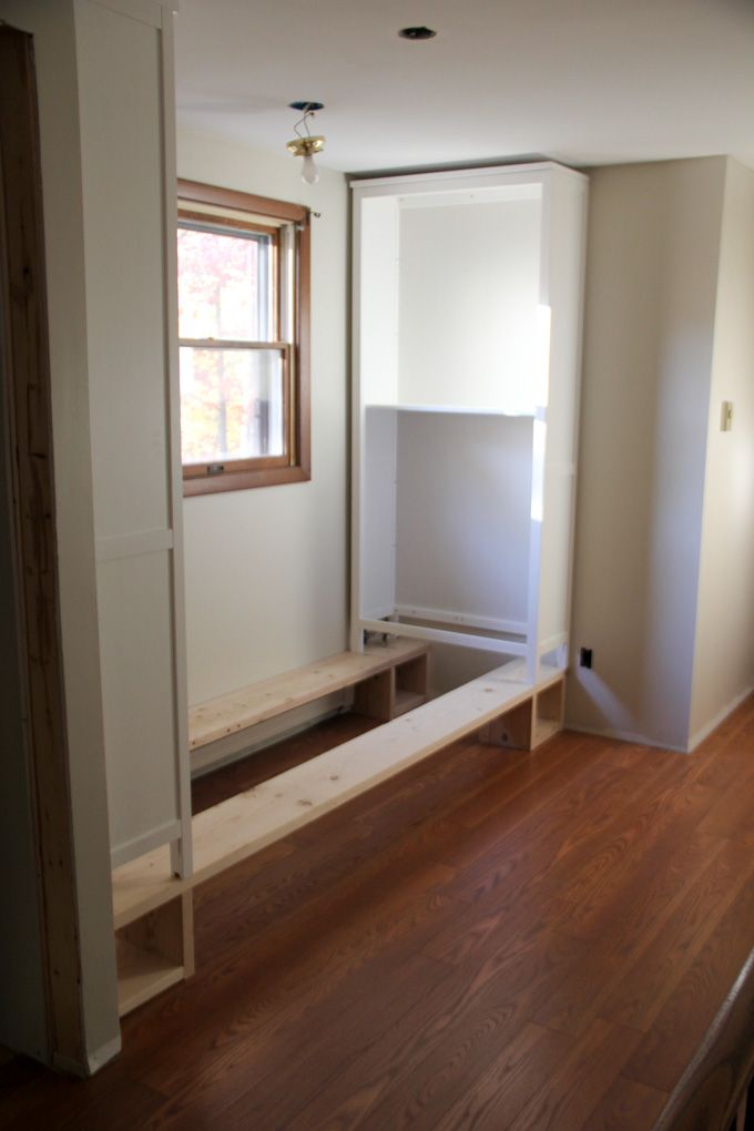 an empty room with wood flooring and white paint on the walls, along with a window