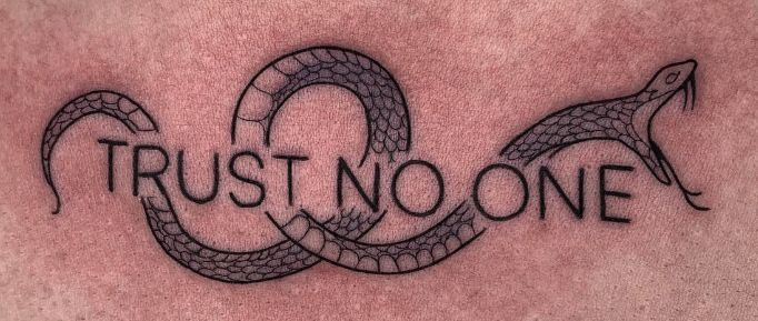 a tattoo with the words trust no one on it