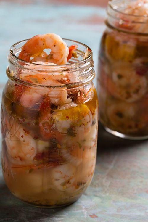 two jars filled with food sitting on top of a table