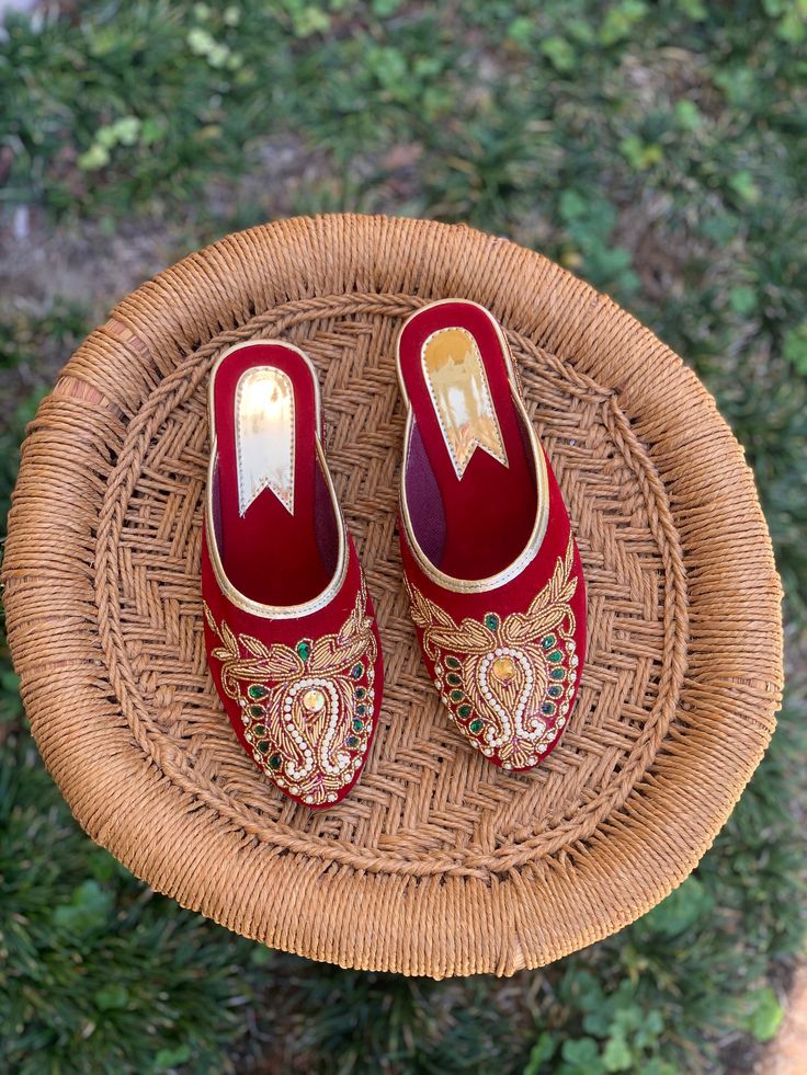 These shoes, paying homage to a heritage of Nepali style and renowned craftsmanship, are handmade and hand embroidered by local Nepalese women artisans and support their artisanal craft.  Due to the nature of handmade natural dye process, the coloring on the insole may fade after few wears. Traditional Handmade Open Toe Mules, Traditional Red Closed Toe Flats, Traditional Handmade Slippers With Round Toe, Traditional Handmade Closed Toe Heels, Traditional Closed Toe Mules For Festivals, Traditional Pointed Toe Mules, Traditional Closed Toe Mules For Festive Occasions, Traditional Slip-on Slippers With Leather Sole, Traditional Handmade Flats