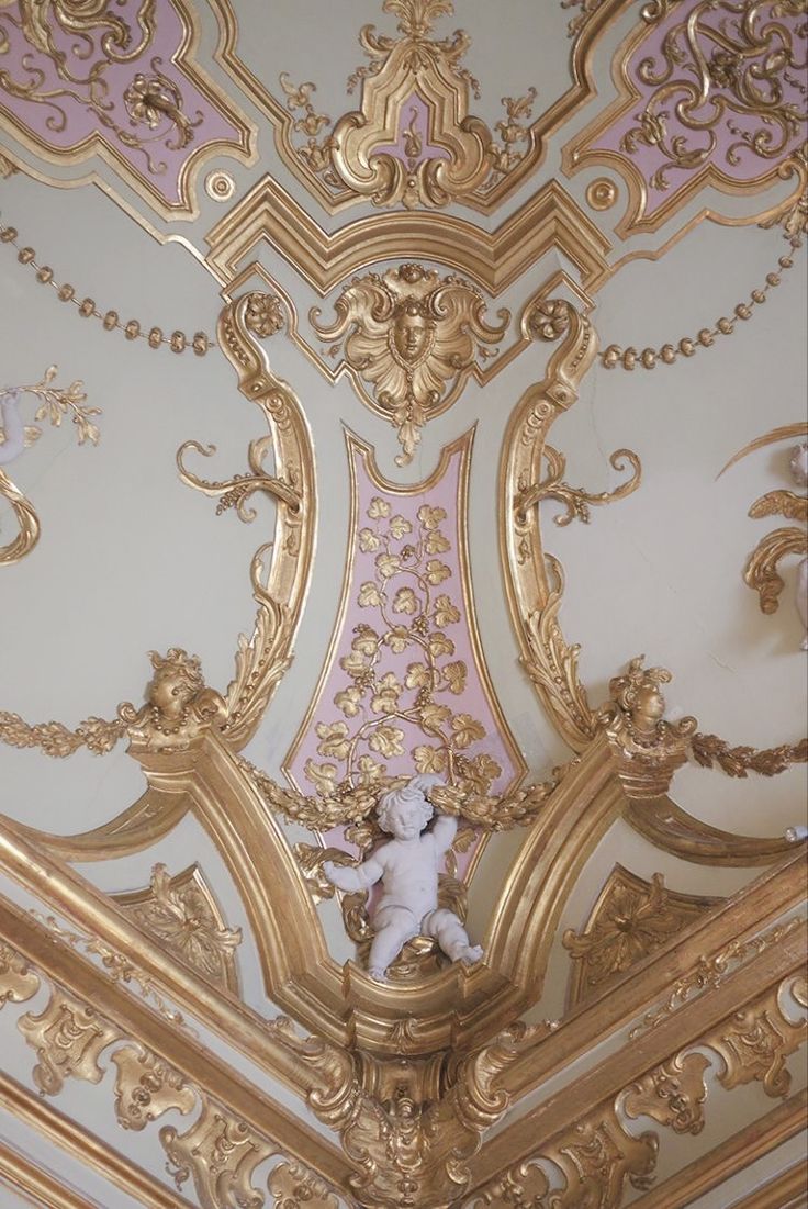 an ornate ceiling with gold and pink paint