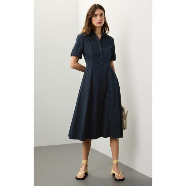 Blue (98% Cotton, 2% Elastane) Cocktail dress. Collared. Short sleeves. Front button closure. 48" from shoulder to hemline. Imported. Classic A-line Cotton Shirt Dress, A-line Shirt Dress With Button Closure For Daywear, Fitted Short Sleeve Midi Dress With Placket, Fitted Midi Dress With Placket And Short Sleeves, Short Sleeve Midi Dress With Placket For Workwear, Semi-formal Button-up Dress With Button Cuffs, Cotton A-line Midi Dress With Button Closure, Summer Cotton Shirt Dress For Business Casual, Classic Midi Dress With Covered Buttons For Daywear