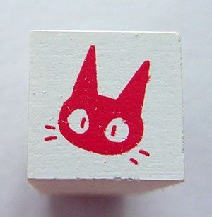 a red and white square with a cat's face drawn on it