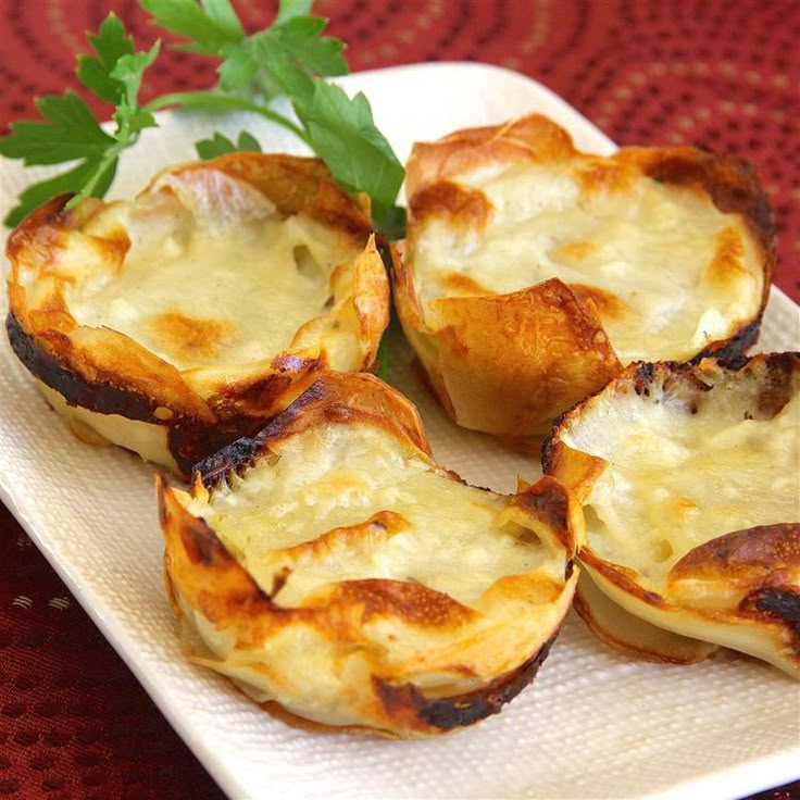 some food is sitting on a white plate with a green leafy garnish