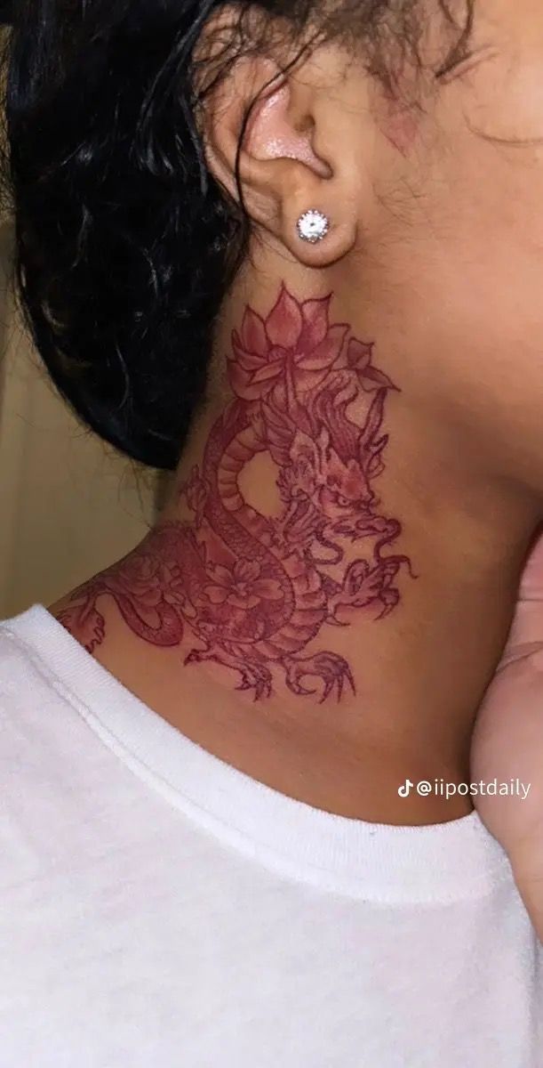 a woman with a flower tattoo on her neck and behind her ear is a cell phone