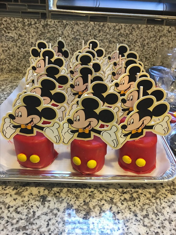 mickey mouse cupcakes are sitting on a tray