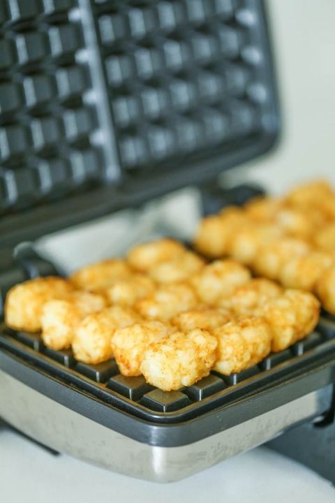 some fried food is sitting on a waffle iron