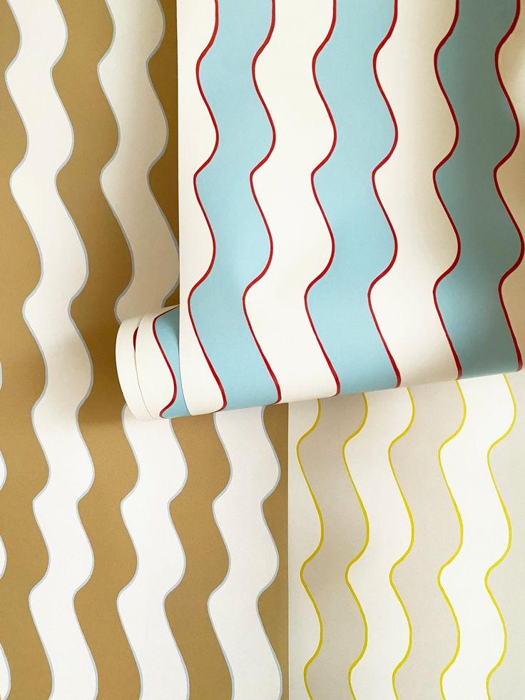 the wallpaper is very colorful and has wavy lines on it, as well as a roll of toilet paper