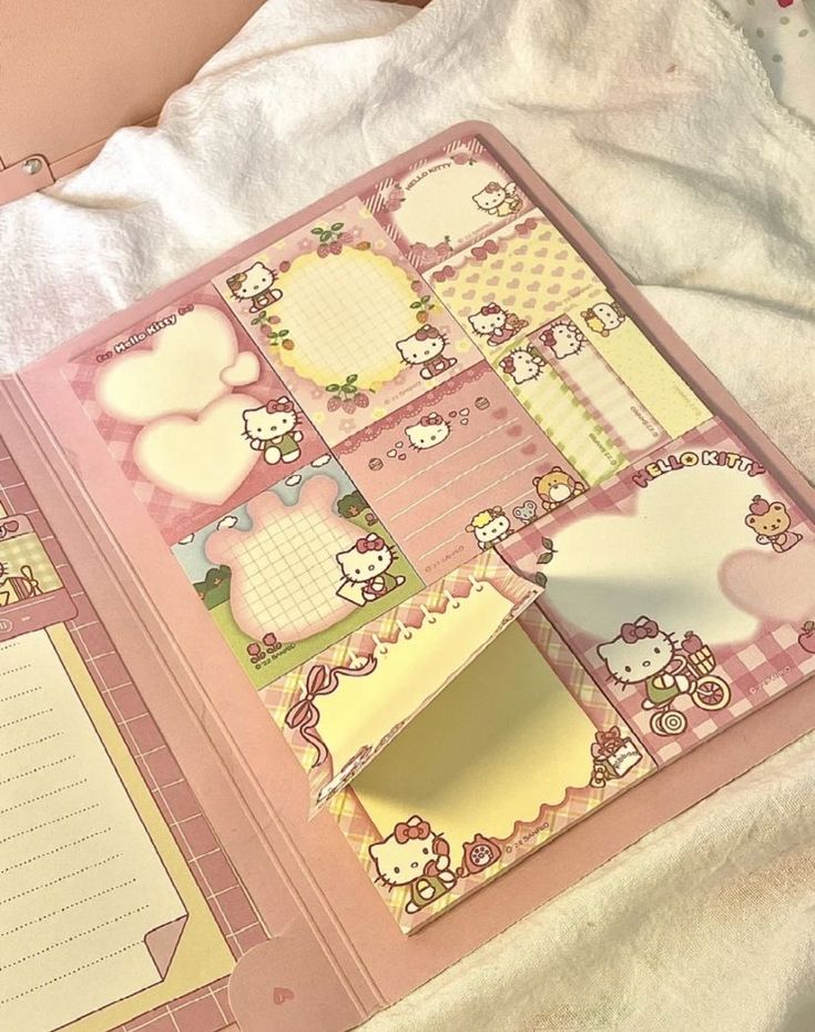 an open hello kitty planner book on a bed