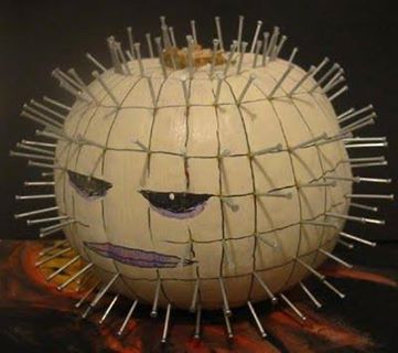 a pumpkin with spikes on it's head and eyes