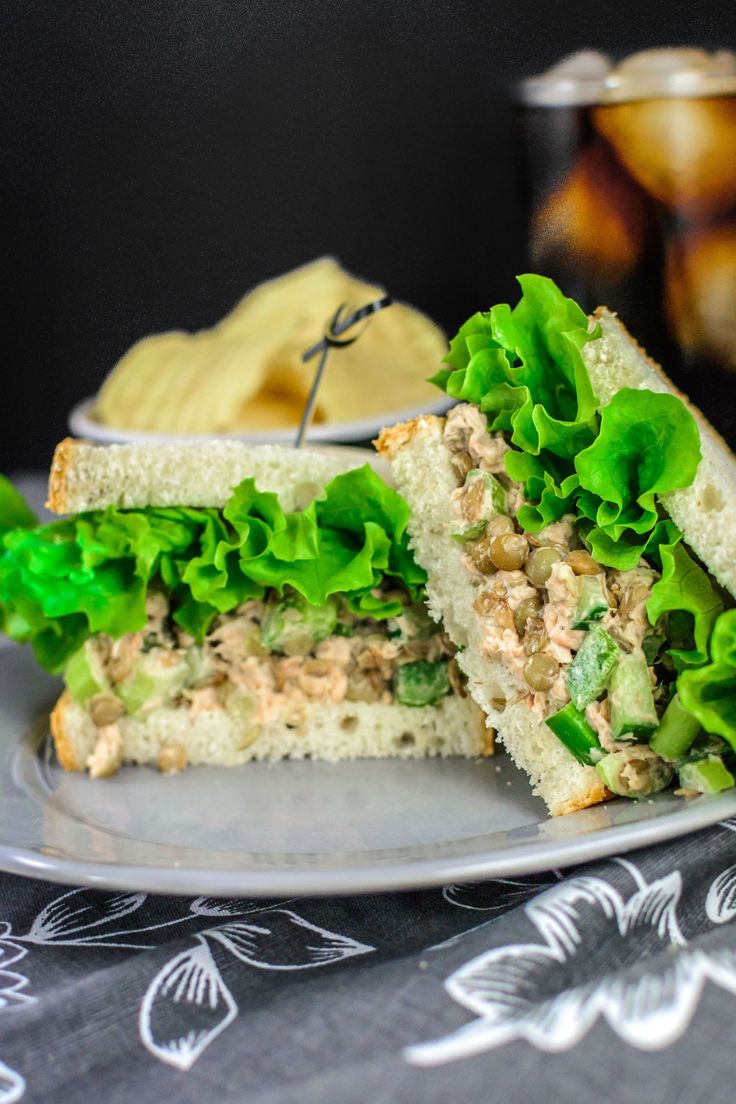 a sandwich cut in half sitting on top of a plate