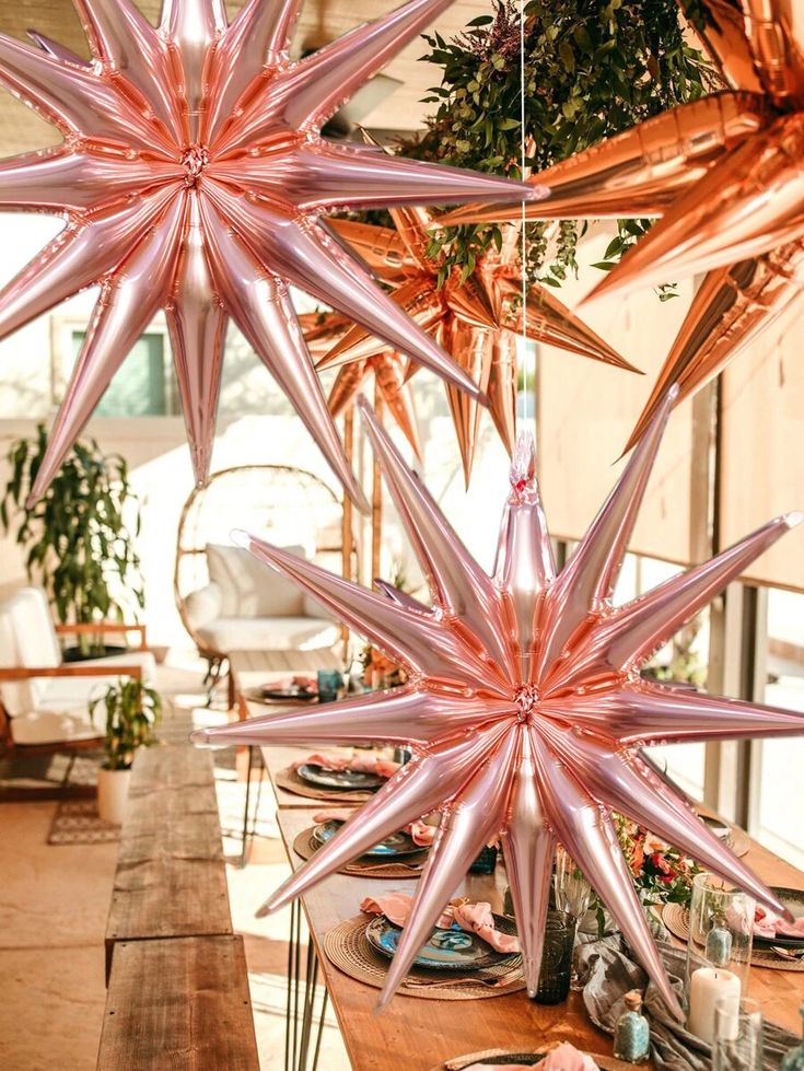 large pink star decorations hanging from the ceiling