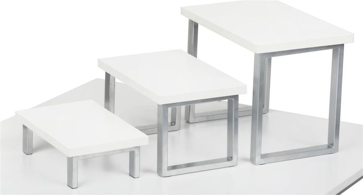 three white tables and two stools sitting on top of each other in front of a white background