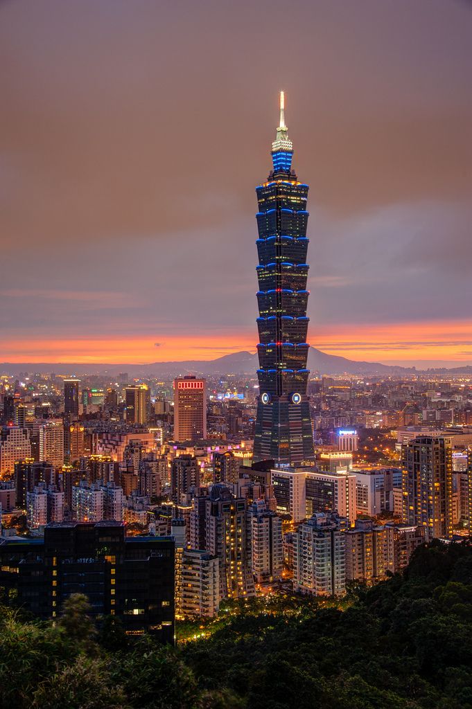 the city skyline is lit up at night