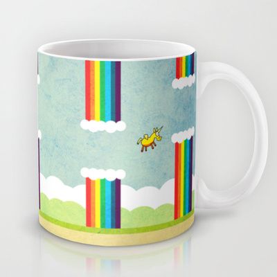 a coffee mug with a bee flying over the rainbows on it's side