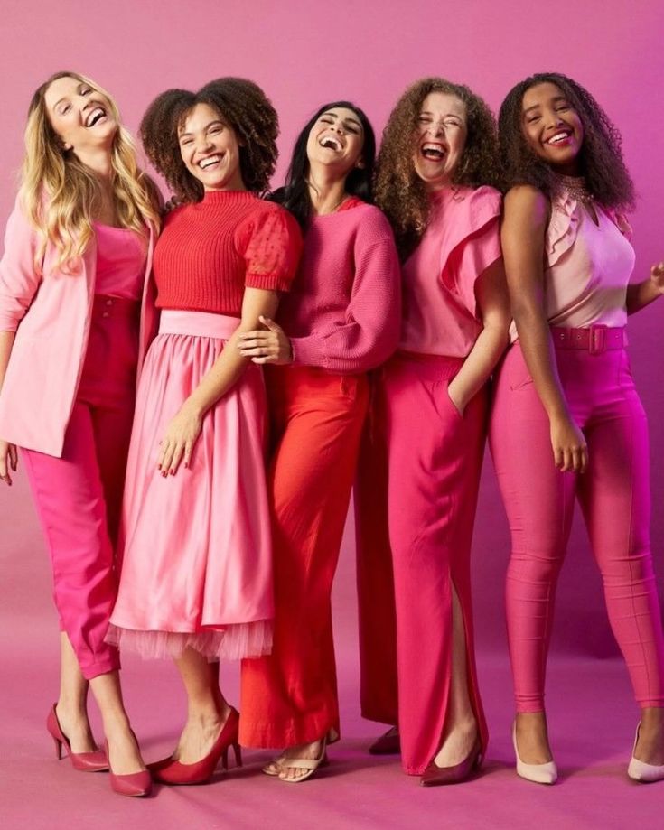 four women in pink and red posing for the camera