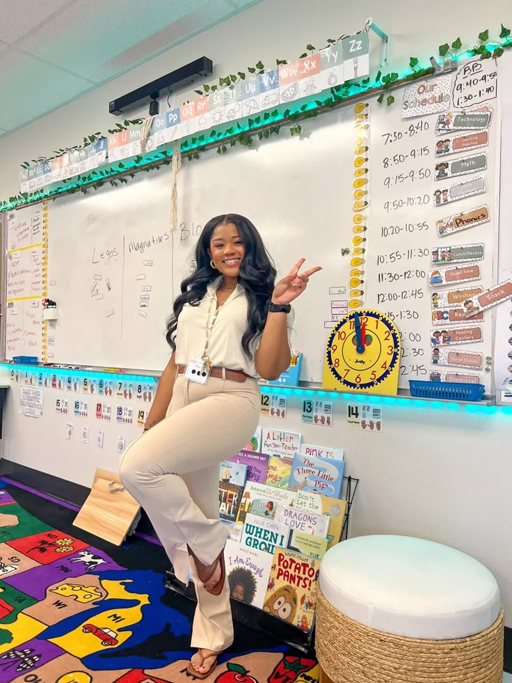 a woman standing in front of a whiteboard with lots of books on the wall