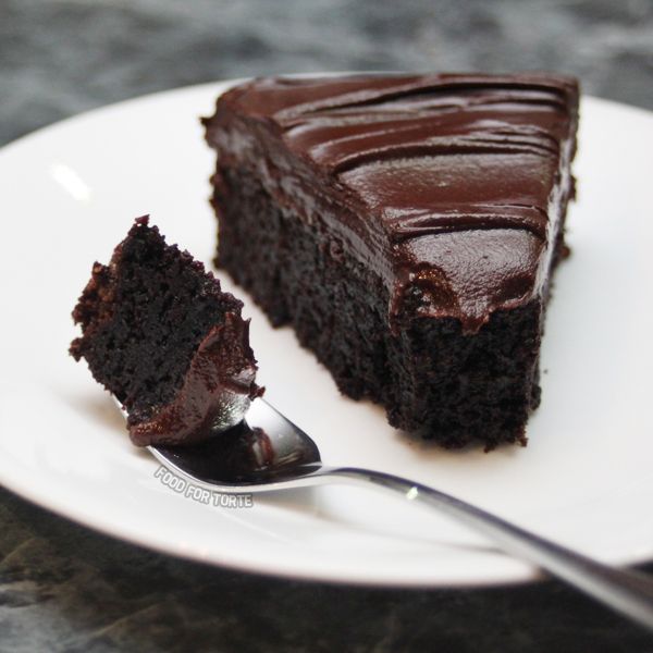 a piece of chocolate cake on a plate with a fork