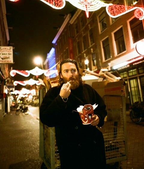 a man standing on the street eating food