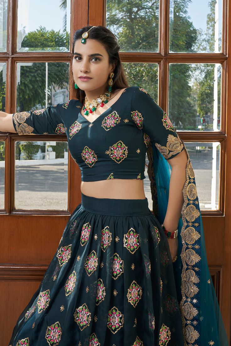 This 3-piece set features a Green Organza Lehenga Choli with Zari, Thread & Sequins Embroidery. It has 4m of flair and a 2.3m length that reaches the floor. It also comes with a Butterfly Net Dupatta and has a Regular Sleeve Unstitched Blouse of 1m with a V Neck. Dry-clean to keep it looking its best. Customizations are available if you include measurements in the order notes. No of piece - 3 piece Color- Green Lehenga Choli Fabric - Organza Stitch Type - Semi-Stitched (Standard Cancan & Canvas